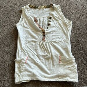 White tank with pocket and neckline details. Size small.